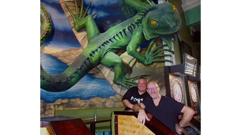Die beiden Besitzer der Gecko Bar Hamburg Bahrenfeld unter der große Gecko Plastik